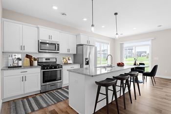 White shaker cabinets w/ black hardware