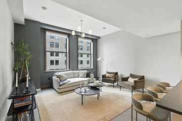Cleveland apartment for rent - A living room with a white couch and a large window.
