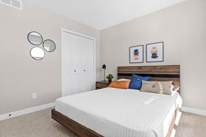 Woodbury apartment for rent - a bedroom with a white bed and two mirrors on the wall