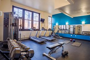 South Bend apartment for rent - A gym with a variety of equipment including treadmills, dumbbells, and weight machines.