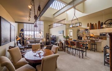 South Bend apartment for rent - A well-lit, spacious open-plan living and dining area with a large table and chairs.