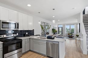 Perrysburg apartment for rent - A modern kitchen with a stainless steel oven and a wooden floor.