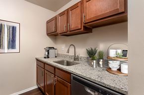 Sappington apartment for rent - a kitchen with granite counter tops and wooden cabinets