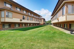 Kalamazoo apartment for rent - a row of apartment buildings with a grass yard