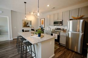Columbus apartment for rent - A kitchen with a white island and stainless steel appliances.