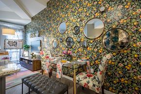 Detroit apartment for rent - A dining room with a floral wallpaper and a table set for two.