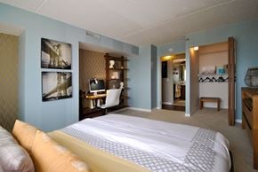 Detroit apartment for rent - a bedroom with a bed and a desk in a hotel room