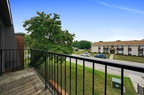 Racine apartment for rent - a balcony with a view of a yard and a building
