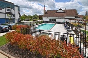 Southfield apartment for rent - a swimming pool at a hotel with a building in the background