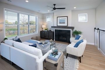 Albertville apartment for rent - a living room with white furniture and a fireplace