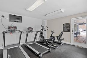 Morrisville apartment for rent - A gym with treadmills, elliptical machines, and a flat screen TV.