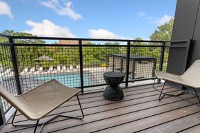 Cleveland apartment for rent - a balcony with two chairs and a table and a pool in the background