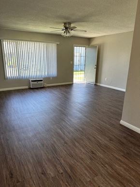 Redlands apartment for rent - an empty living room with a ceiling fan