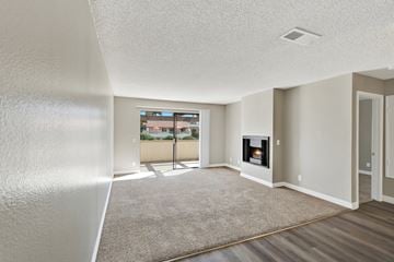Fullerton apartment for rent - A living room with a fireplace and a carpet on the floor.