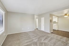 Brea apartment for rent - A spacious room with a carpeted floor and a ceiling fan.