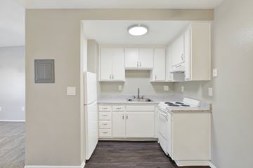 Brea apartment for rent - A kitchen with white cabinets and appliances.