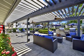 Brea apartment for rent - A patio with a white roof and blue chairs.