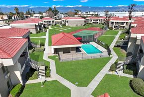 Colton apartment for rent - A view of a courtyard with a tennis court and a pool.