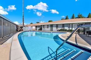 Redlands apartment for rent - A swimming pool with a metal fence around it.