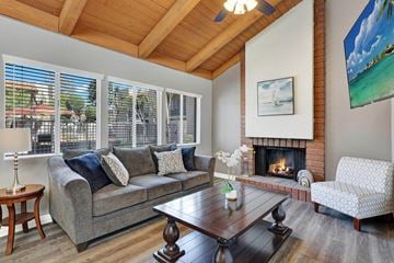 Fountain Valley apartment for rent - A living room with a grey couch and a fireplace.