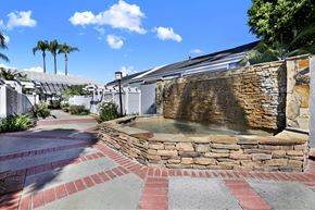 Fullerton apartment for rent - A stone fountain in the middle of a brick walkway.