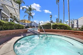 Fullerton apartment for rent - A hot tub sits in the middle of a brick patio.