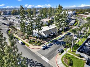 Fullerton apartment for rent - A sunny day in a suburban area with a parking lot and trees at THE STREAMS Apartments, Fullerton, 92831