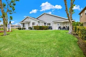 Midway City apartment for rent - A house with a well-maintained lawn and trees in front.