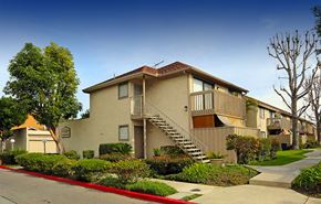 Garden Grove apartment for rent - A beige house with a red roof and a brown door.