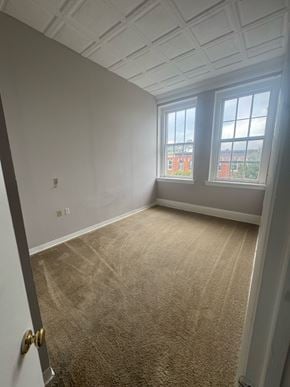 Baltimore apartment for rent - Representative Peabody Unit 304 bedroom with two windows and carpet.