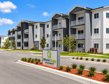 Lakeland apartment for rent - A Gibson Oaks Apartments sign is in front of a building.