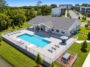 Lakeland apartment for rent - an aerial view of a swimming pool and patio furniture at Gibson Oaks, Lakeland, 33809