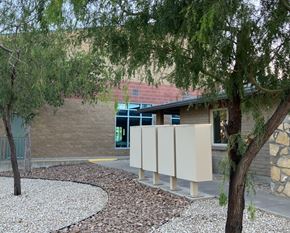 El Paso apartment for rent - A building with a curved walkway and trees in front.