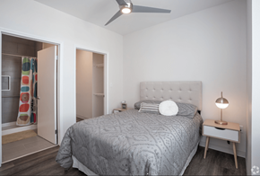 El Paso apartment for rent - A bedroom with a bed, nightstand, and a ceiling fan.