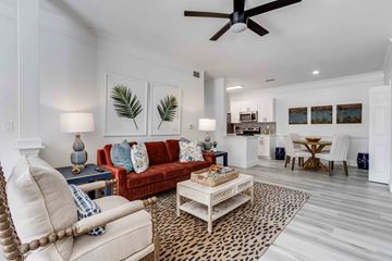 Summerville apartment for rent - A living room with a red couch and a leopard print rug.