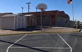 El Paso apartment for rent - A basketball court with a basketball hoop and a portable building in the background.