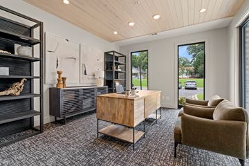 Greer apartment for rent - A modern living room with a wooden coffee table and a large window.