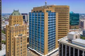 El Paso apartment for rent - A cityscape with a large building in the foreground and a green dome building in the background.