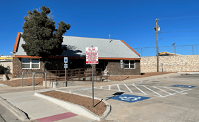 El Paso apartment for rent - A parking lot with a building and a sign in front of it.