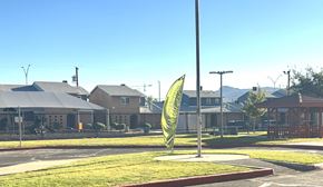El Paso apartment for rent - A green sign with a yellow arrow is in the middle of a grassy area.