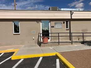 El Paso apartment for rent - A building with a yellow and black striped parking lot in front.