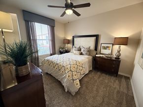El Paso apartment for rent - A bedroom with a bed, nightstand, and a ceiling fan.