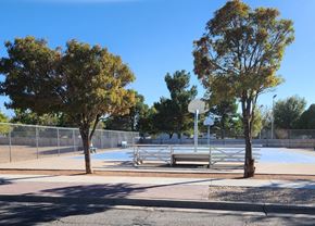 El Paso apartment for rent - A park with a bench, a basketball court and a fence.