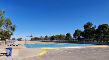 El Paso apartment for rent - A blue and yellow pool with a fence around it.