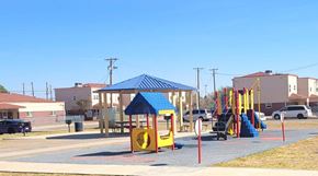 El Paso apartment for rent - A playground with a blue canopy and a yellow slide.