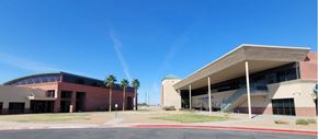 El Paso apartment for rent - A modern building with a curved roof and a staircase leading to the entrance.