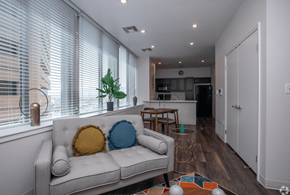 El Paso apartment for rent - A living room with a couch, a table, and a potted plant.
