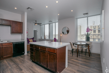 El Paso apartment for rent - A kitchen with a white counter top and wooden cabinets.