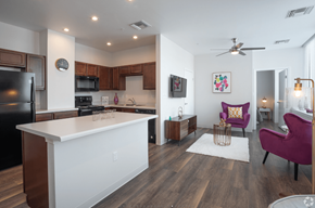 El Paso apartment for rent - A kitchen with a white island and purple chairs.