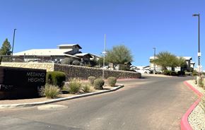 El Paso apartment for rent - A street view of Medano Heights with a building in the background.